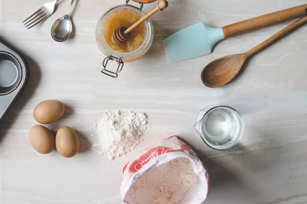 Top view of successful gluten free baking ingredients on a white table.