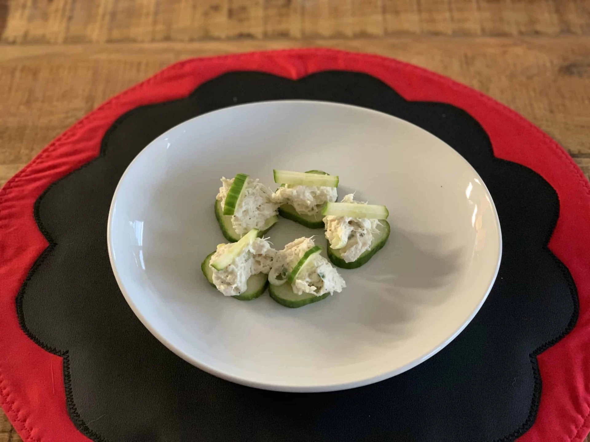 A white plate with cucumbers on it.
