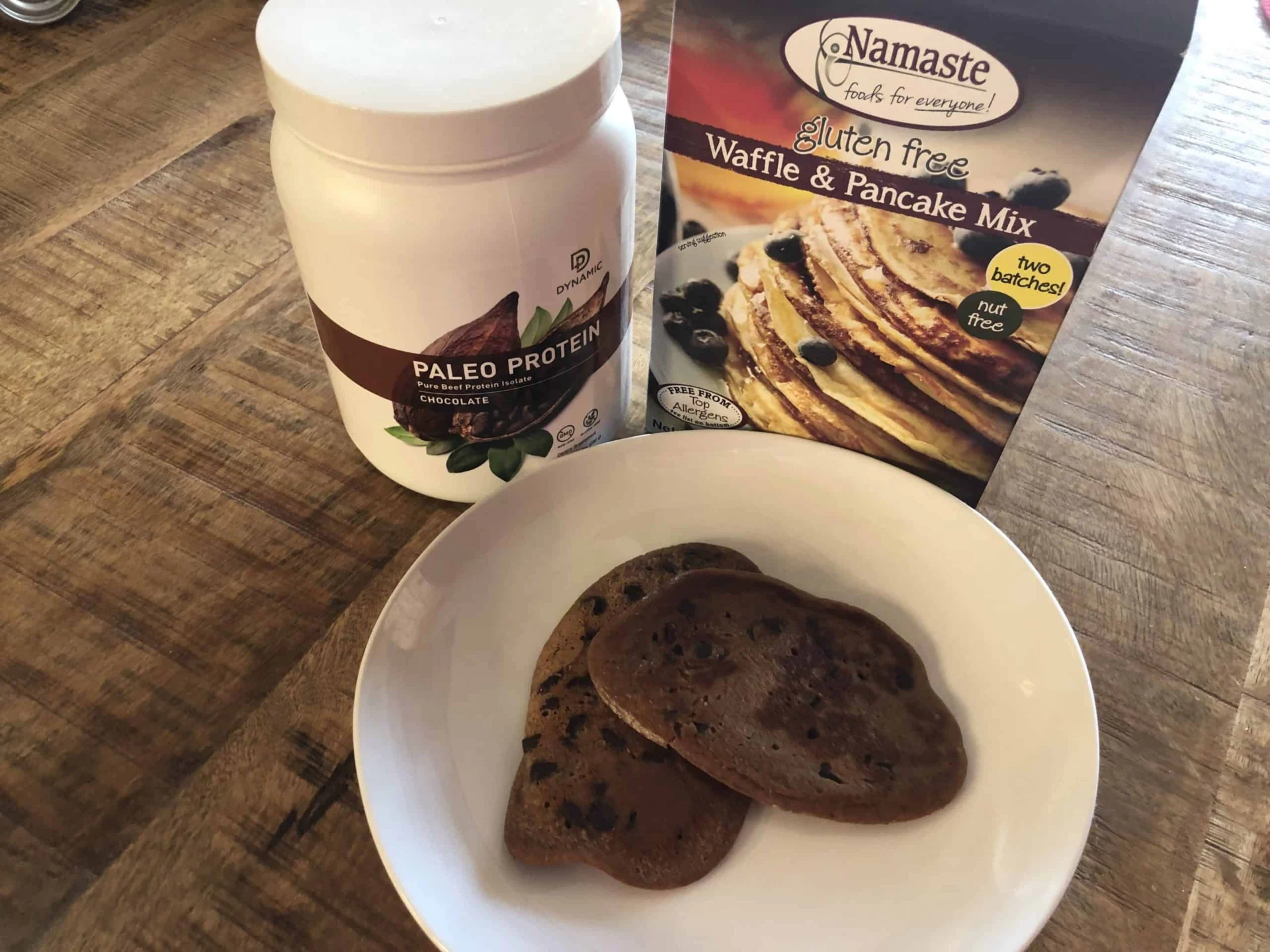 A plate of pancakes and a package of pancake mix.